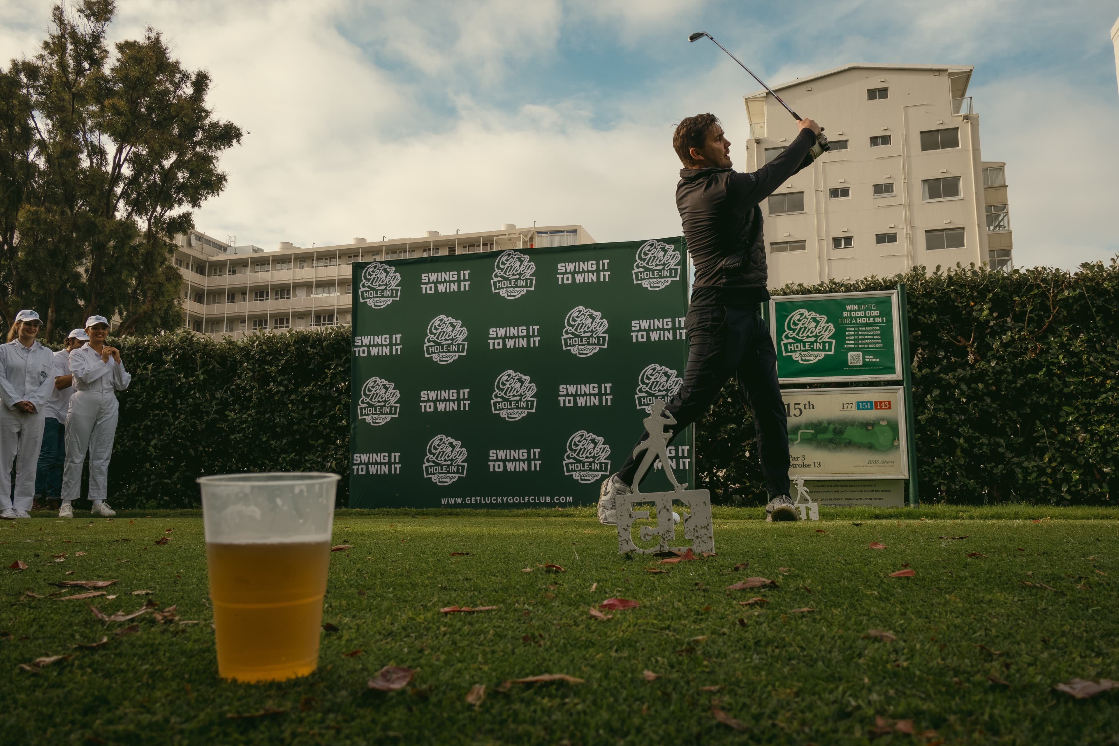 Golfer mid-swing at the Get Lucky Hole-in-One Challenge activation