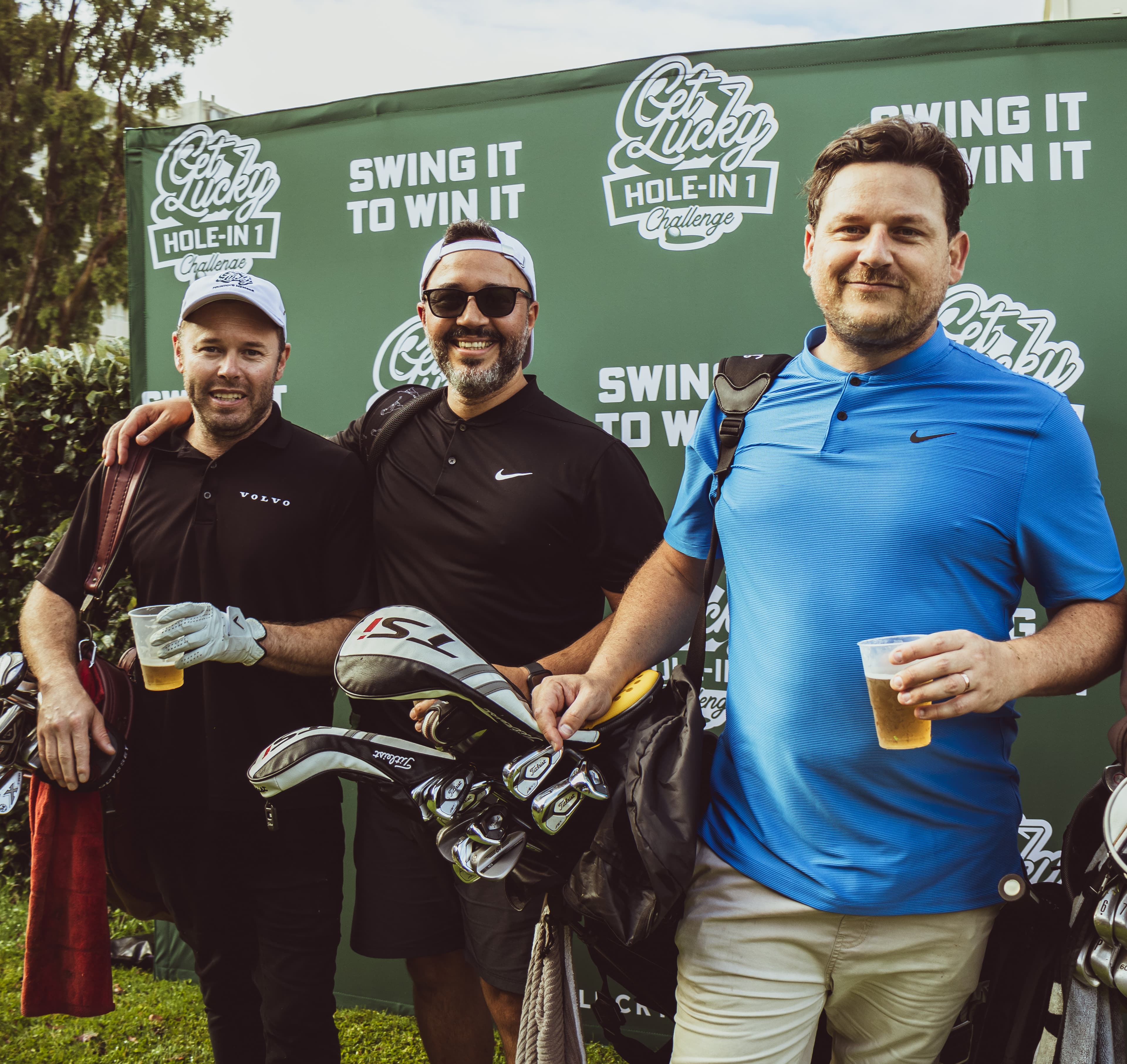 Three golfers with beers at the Get Lucky activation