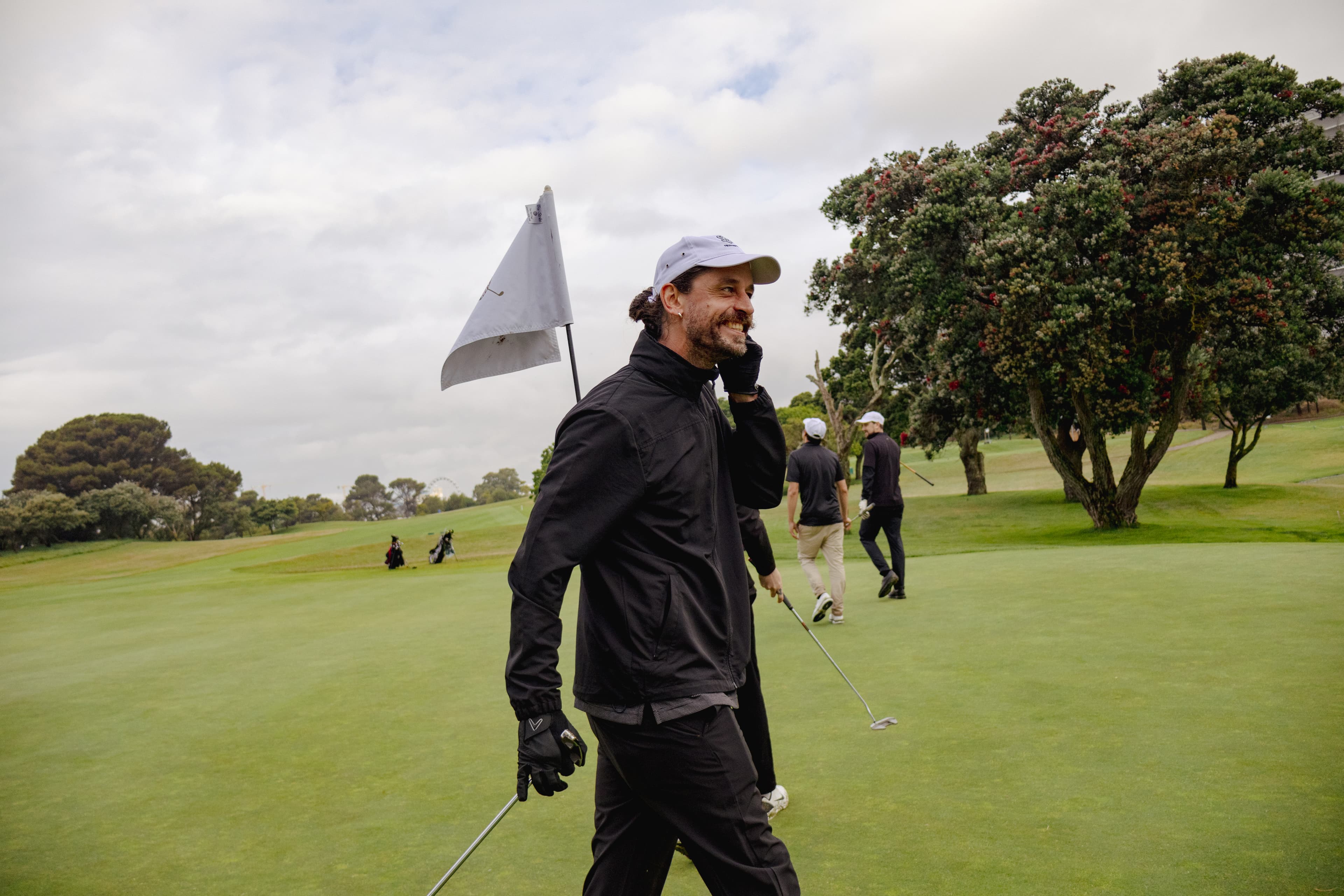 Golfer on the green with the flag